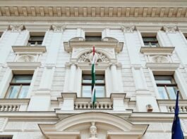 a large white building with a wooden door