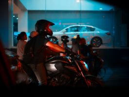 man riding gray naked motorcycle near people