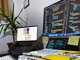 a stack of books sitting in front of a computer