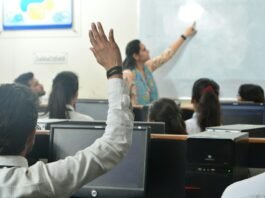 Students and teacher in a computer classroom.