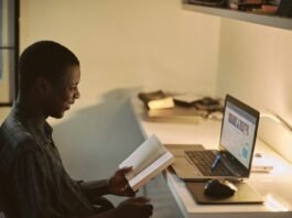 man in black dress shirt using laptop computer