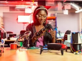 a woman looking at a piece of electronic equipment