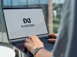Person typing on laptop with ai gateway logo.