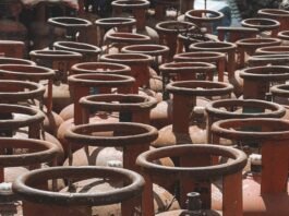 Rusty gas cylinders aligned outdoors in Nepal, showcasing industrial storage.